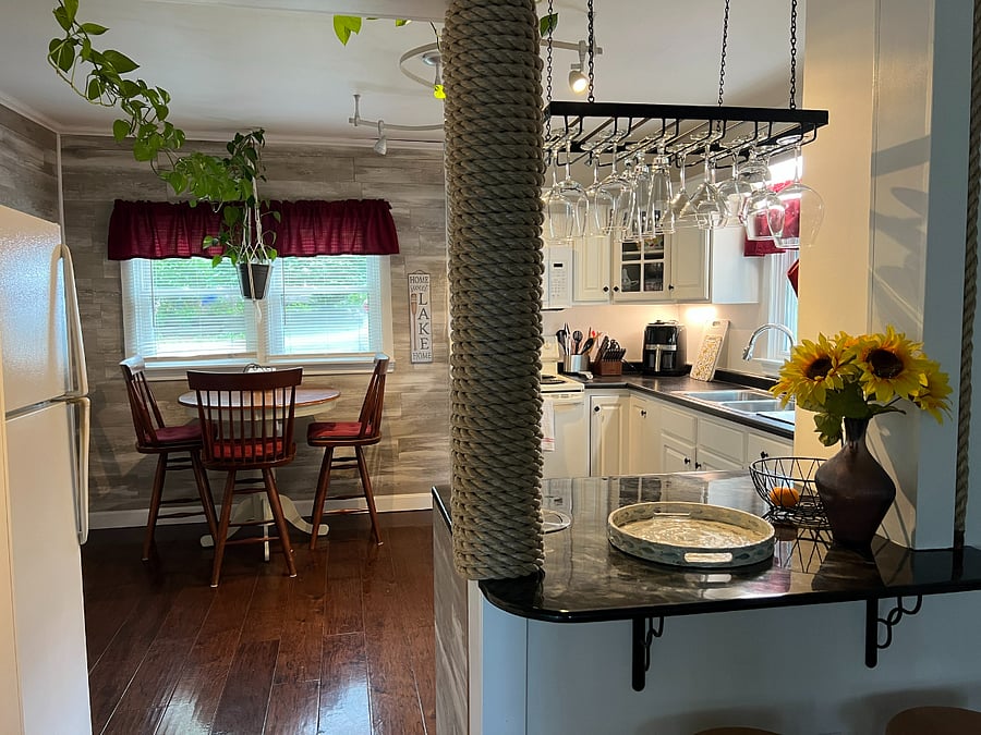 Dining table has 4 chairs and 2 stools.