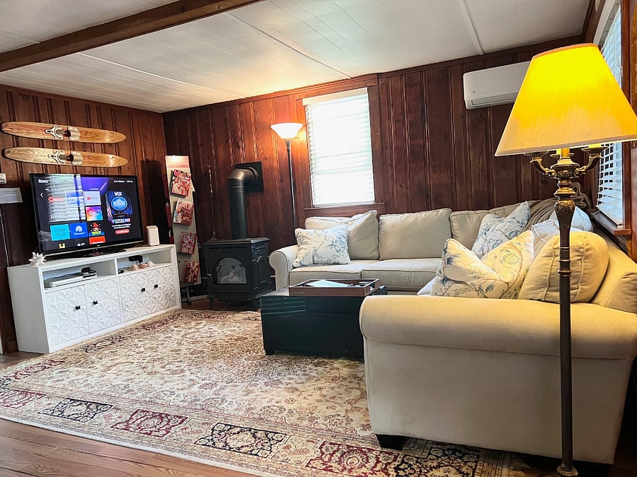 Living features large comfy L shaped couch w/ extra large TV and Direct Vent fireplace stove that provides both ambiance and heat++