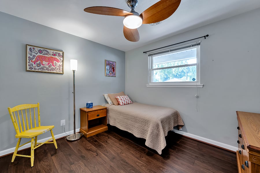 Twin bedroom with comfortable mattress and sitting area.