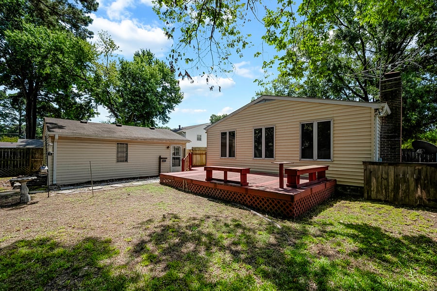 View of deck and back of house (also visible is the garage, which is not accessible).