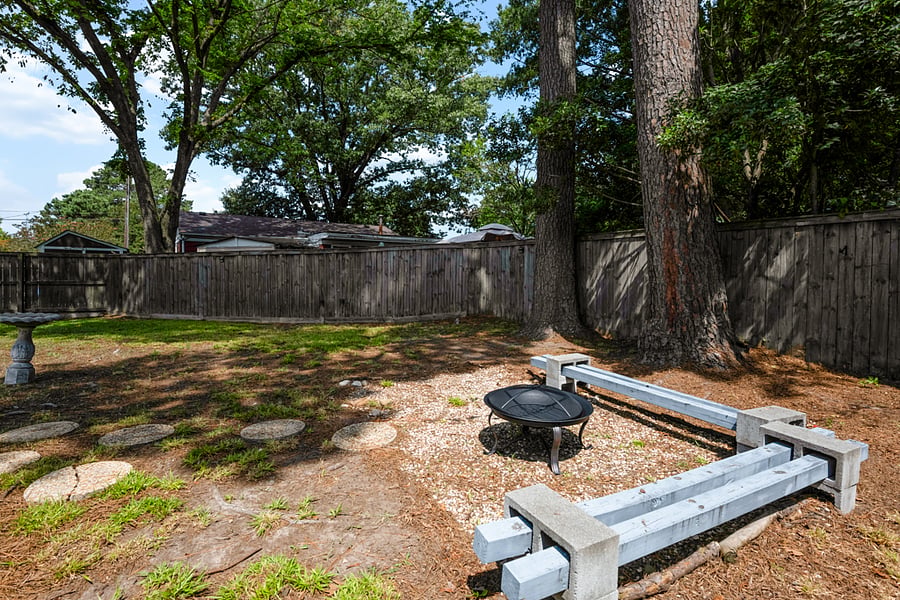Shady yard with fire pit.