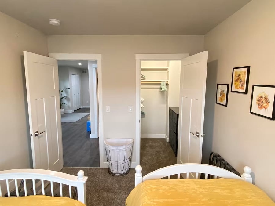 Each bedroom has a walk-in closet with extra pillows and blankets, and the twin room closet also holds the dresser.