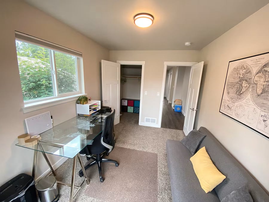 A small seating area and walk-in closet with storage are available in this dedicated office space.