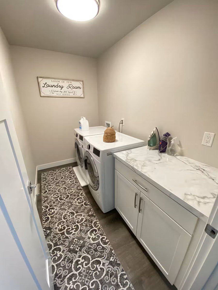 Free laundry available in unit, with basic laundry supplies including laundry soap, dryer sheets, dryer balls, a drying rack, iron, ironing pad, steamer, spray bottle, stain remover and lint roller.