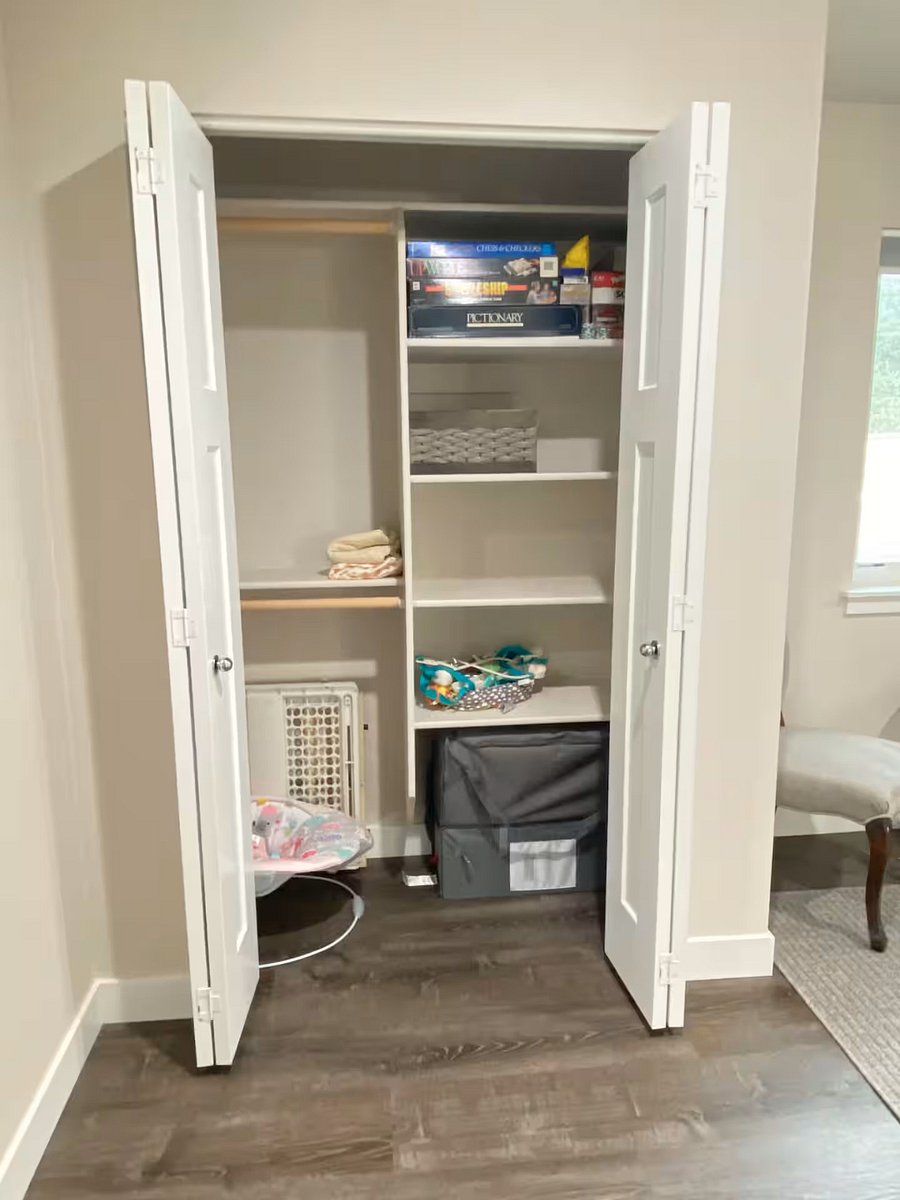 Closet to the left of the area is stocked with games and kids accessories: Pack'n'play crib w/ sheets, two baby gates, and both a doorframe and floor bouncer.