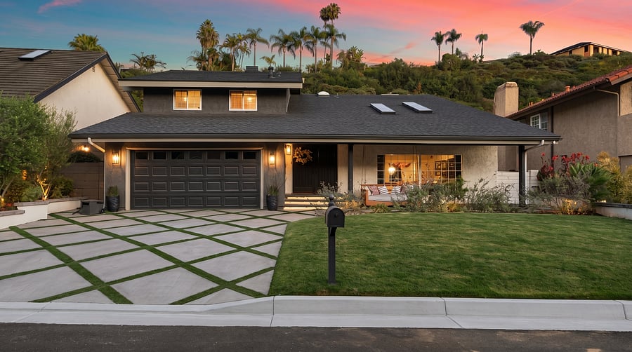 Striking Exterior
Welcome to your dream stay! This beautiful 2-story home shines at twilight, featuring a sprawling green lawn, geometric-patterned driveway, and warm exterior lighting set against a stunning sunset over palm-lined hills.