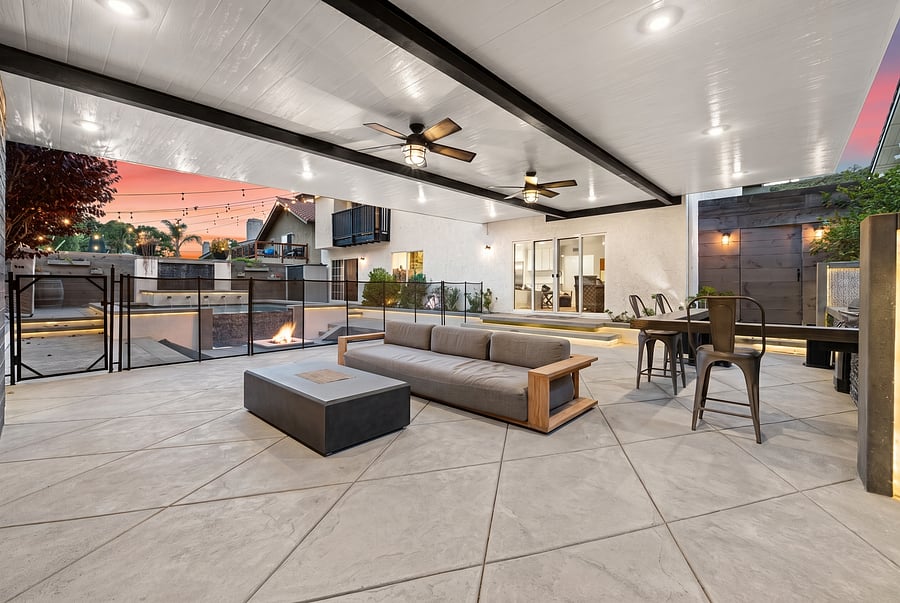 Covered Patio to Poolside Lounge
Seamless outdoor relaxation! Lounge comfortably under the covered patio on plush seating, just steps from the fenced-in pool, glowing fire pit, and sliding doors leading back inside.