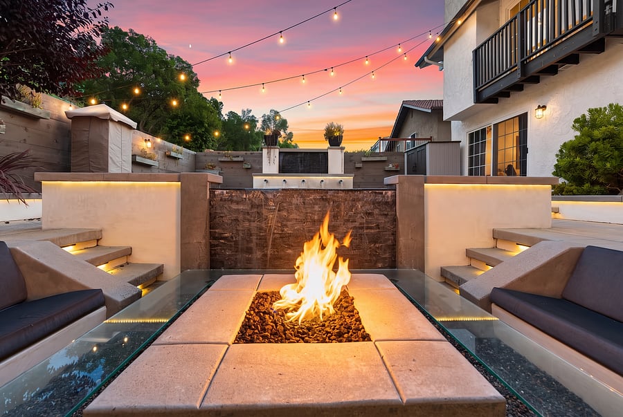 Sunken Fire Pit Lounge & Waterfall Feature
Cozy up by the fire! Enjoy this sunken fire pit with built-in lounge seating, a cascading waterfall backdrop, and glowing LED accents beneath a vibrant twilight sky. Pure resort-style luxury.