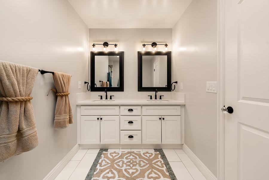 Master En-Suite Bathroom
Get ready effortlessly! This 2nd-floor master bath double vanity offers dual sinks, matte black fixtures, stylish lighted mirrors, and generous counter space-perfect for seamless morning routines.