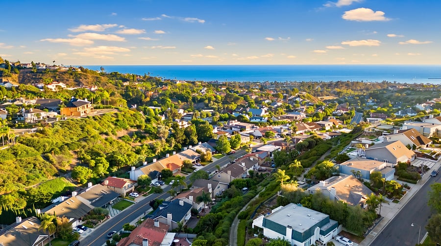 Hillside Neighborhood
Coastal views await! Panoramic hillside perspective of this vibrant, terraced neighborhood, winding through lush greenery all the way to the sparkling blue ocean on the horizon.