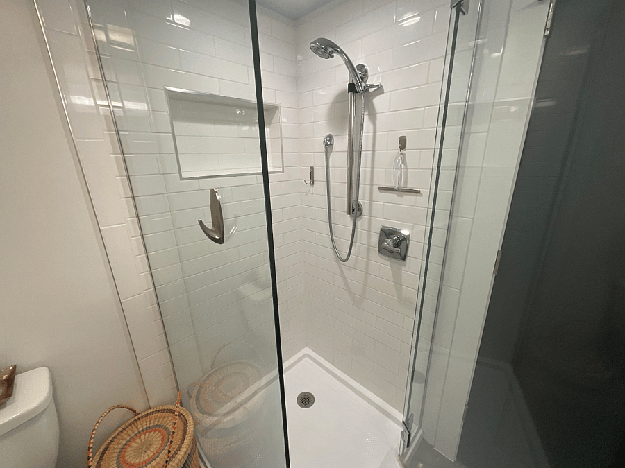 Private bathroom with niche, ADA rated adjustable shower head.