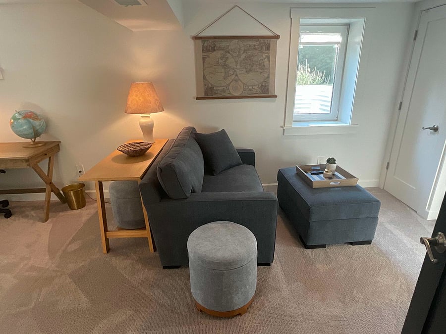 Brand new couch in living area. Egress window.