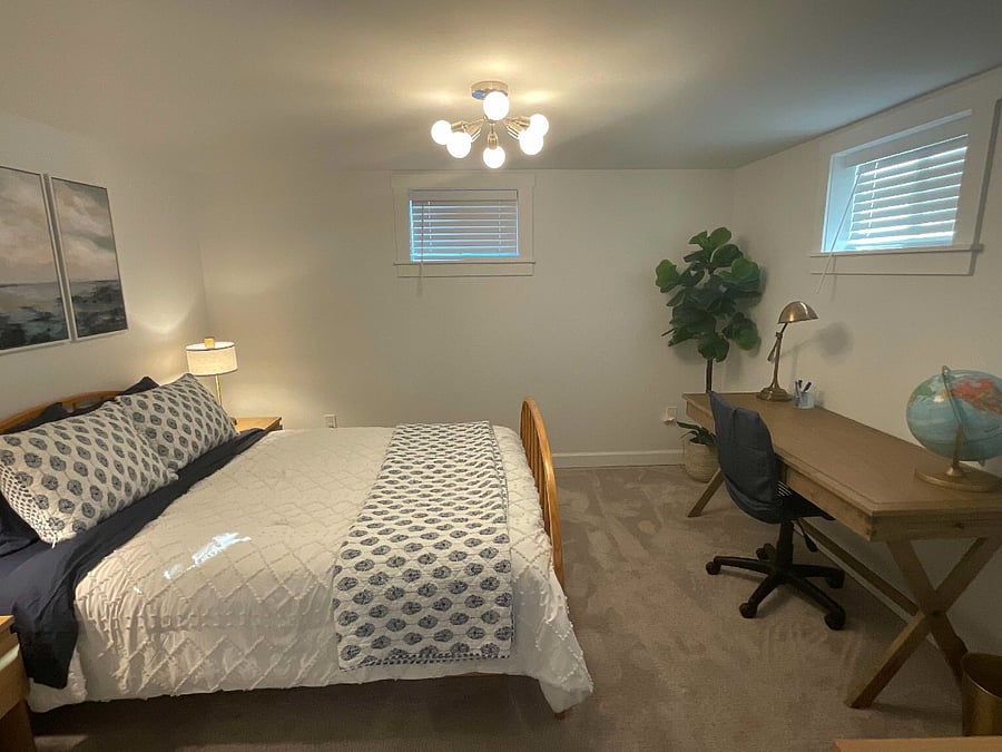 Queen bed with new bedding.
