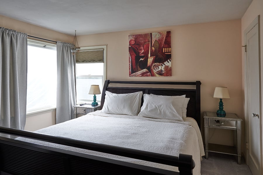 The master bedroom has a king-sized Heavenly Bed mattress, comfortable linens, blackout curtains, cedar closets, and plenty of drawers & hangers. The big window overlooks the park across the street.