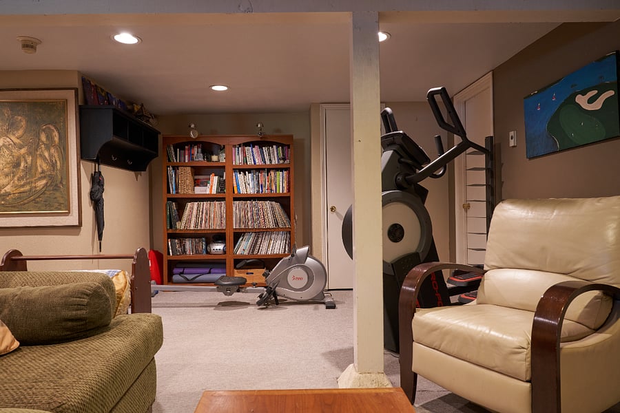 Workout equipment: Rowing machine, Proform Carbon HIIT Elliptical, yoga mats, and light weights
