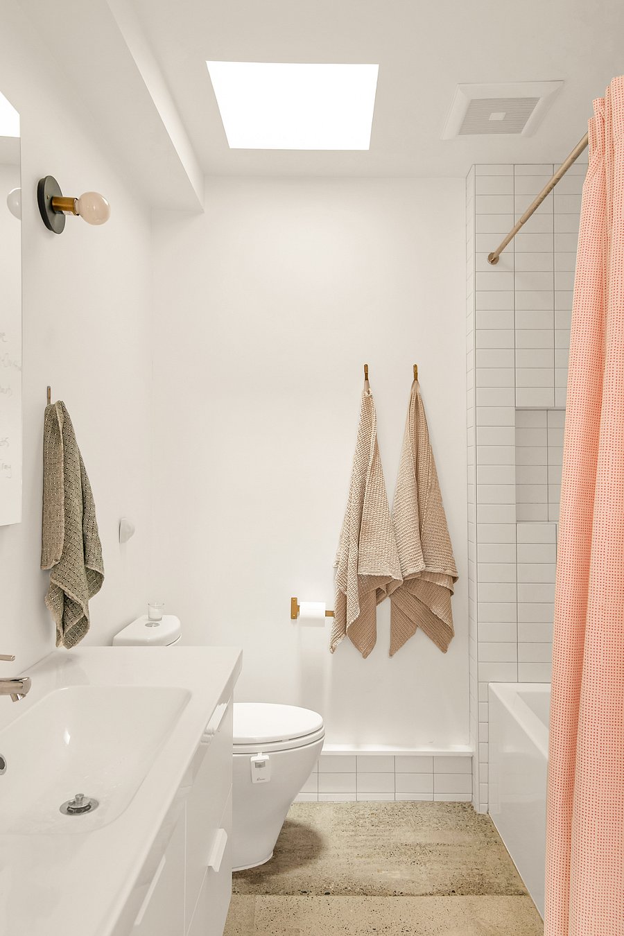 Bathtub with dimmer light above. Skylight in bathroom.