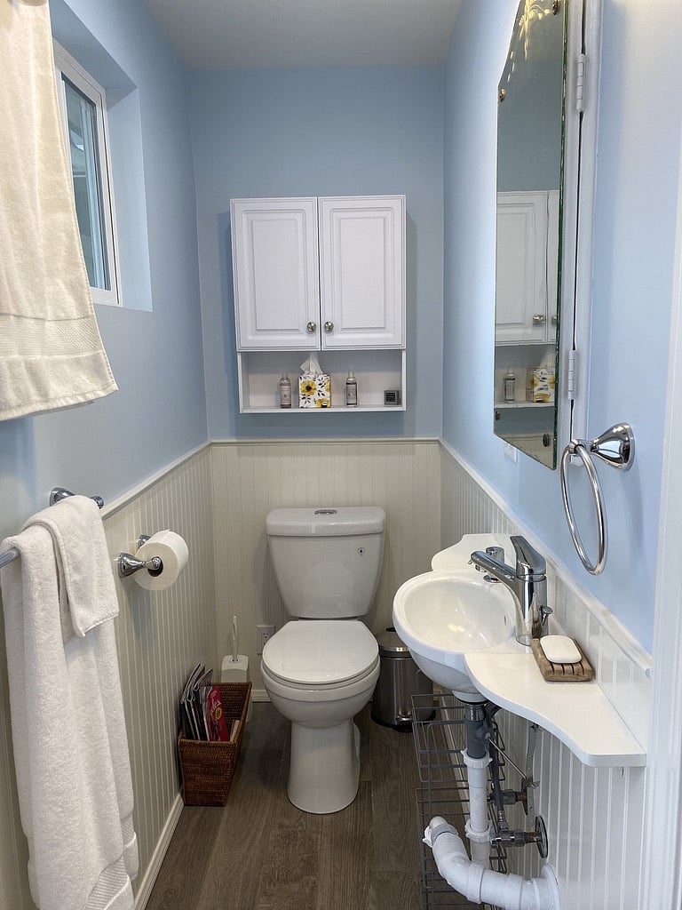 Compact but big enough for everything you need in a bathroom, including hair dryer and makeup mirror.