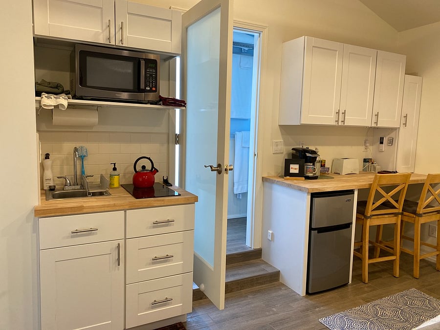 Kitchenette with ample cabinet storage.