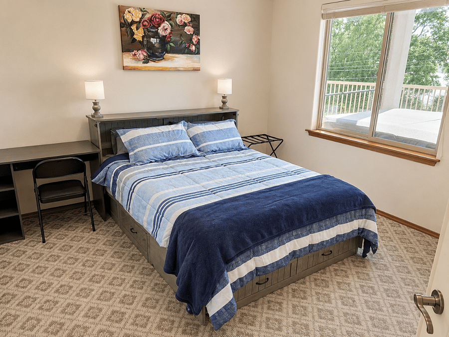 Queen bedroom with lake view and desk space