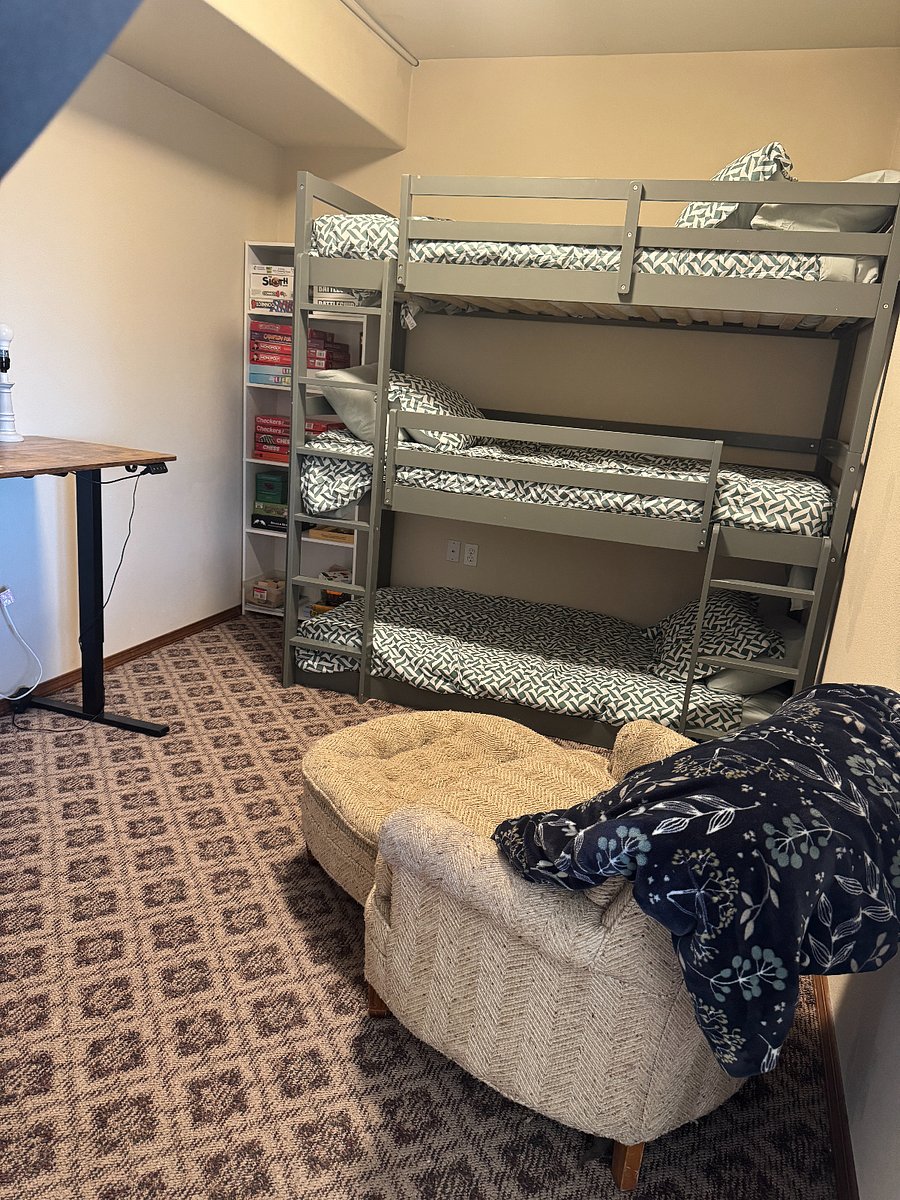 Spare room with standing desk, bunk beds, and games