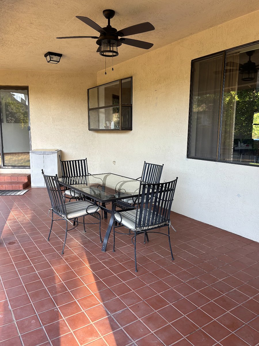 Covered patio accessed from eating area and primary bedroom. Has fan and lights for warm evening relaxing or dining.