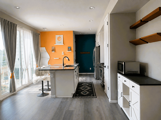 Living area flows into the dine-in kitchen with 4 barstools. 