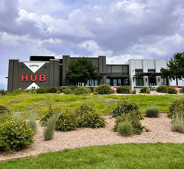 View is the front of the HUB which includes gas firepits and both covered & uncovered outdoor seating.  Location on the high point in the community affords fantastic mountain views, including Long's Peak. 
