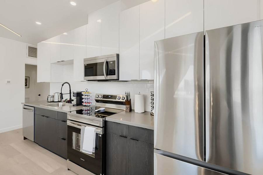 Kitch with , Dishwasher, Microwave, Refrigerator, Stove, Oven, Coffeee Maker, Toaster, and Kettle