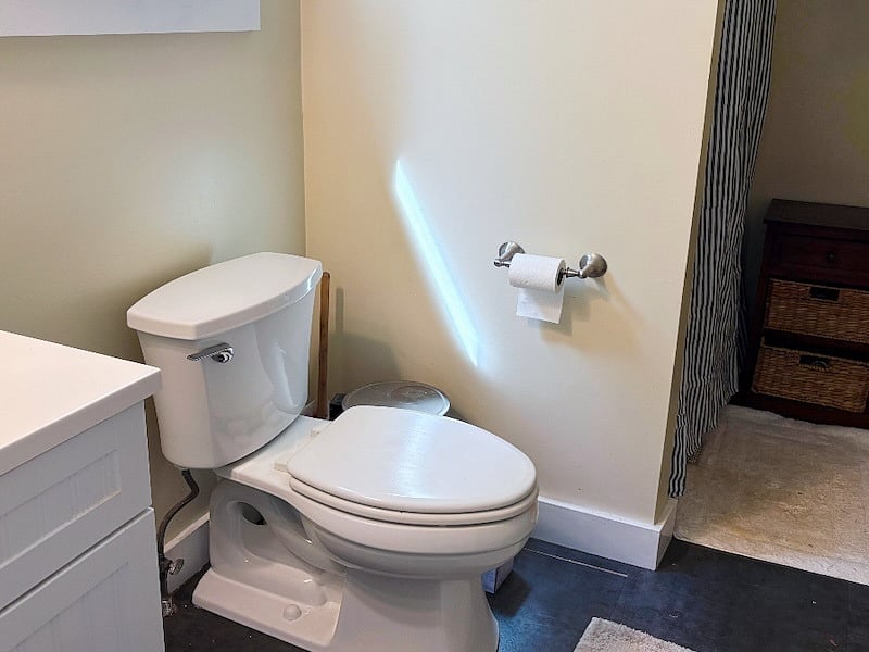 Private bathroom with rainfall shower, next to bedroom.