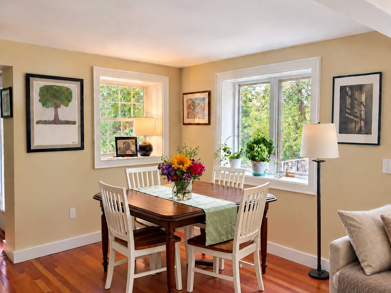 Dining area with expandable table, chairs, extra seating if needed, and scenic views of the backyard.