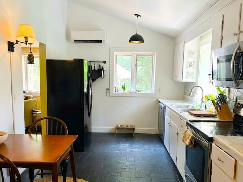 Fully equipped kitchen with generous counter space and a two-person breakfast nook.
