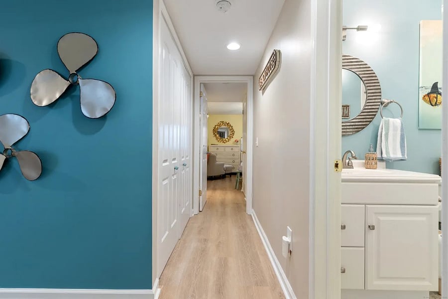 Hallway to master. Laundry is behind bifold doors.G