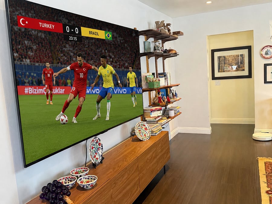 The spacious living room features a stunning 98-inch TV, making it the perfect gathering place for game day, movie nights, or streaming your favorite shows.