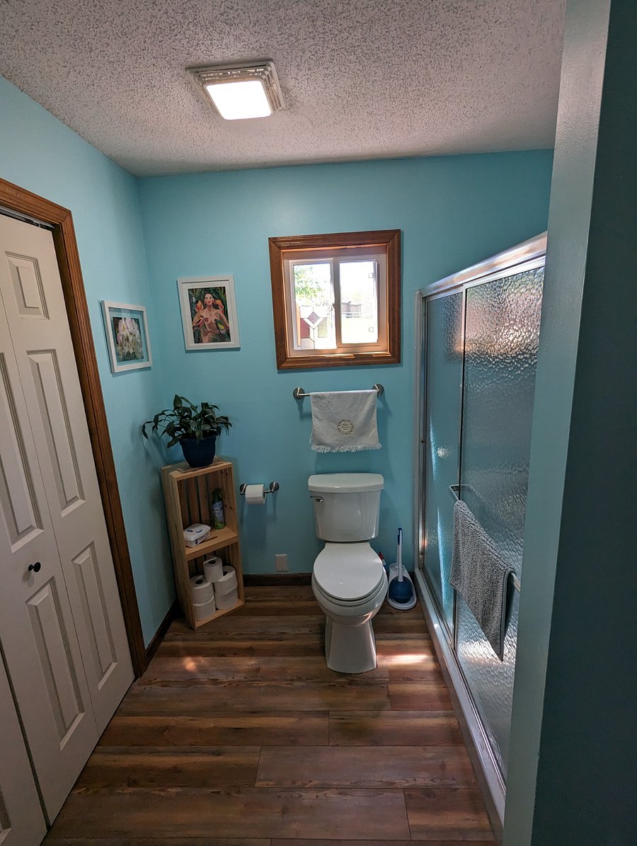 Downstairs bathroom with walk in shower and laundry area.