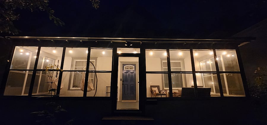 Relax on the screened porch under the string lights