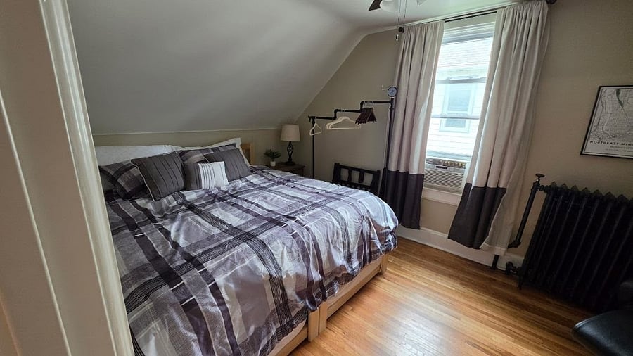 Spacious north upstairs king bedroom with seasonal window air conditioner