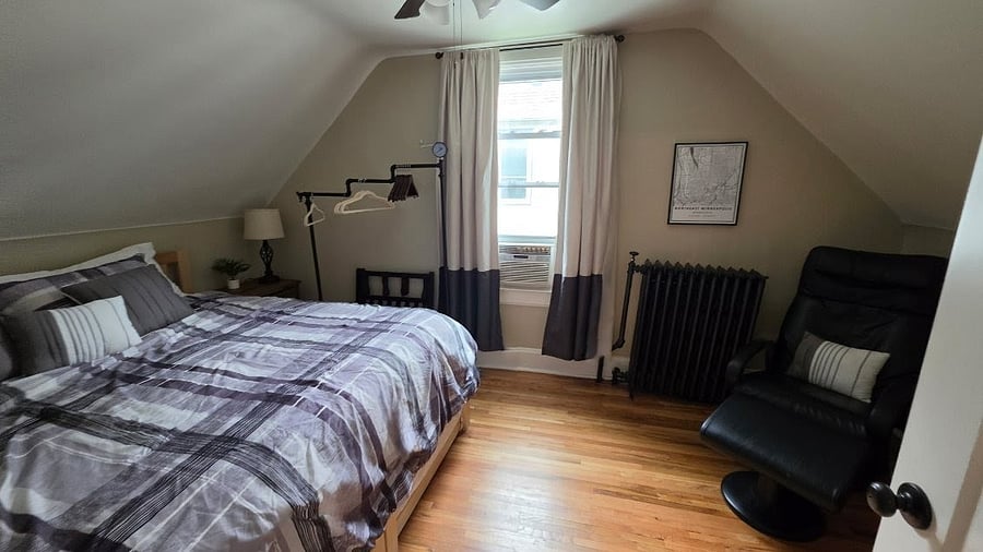 King bed, blackout curtains, massage chair, and workspace create a comfortable retreat.