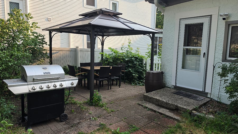Just outside the back door, the private patio includes a full-size gas grill and covered outdoor dining-an easy setup for everyday meals and longer furnished stays.