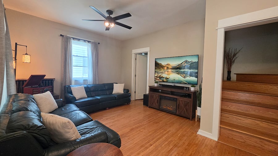 Main living area with Samsung Frame TV and stairs to the upstairs bedrooms.