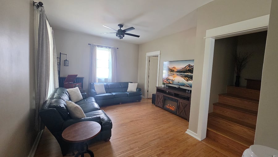 View of the living room, showing the seating layout and natural light.