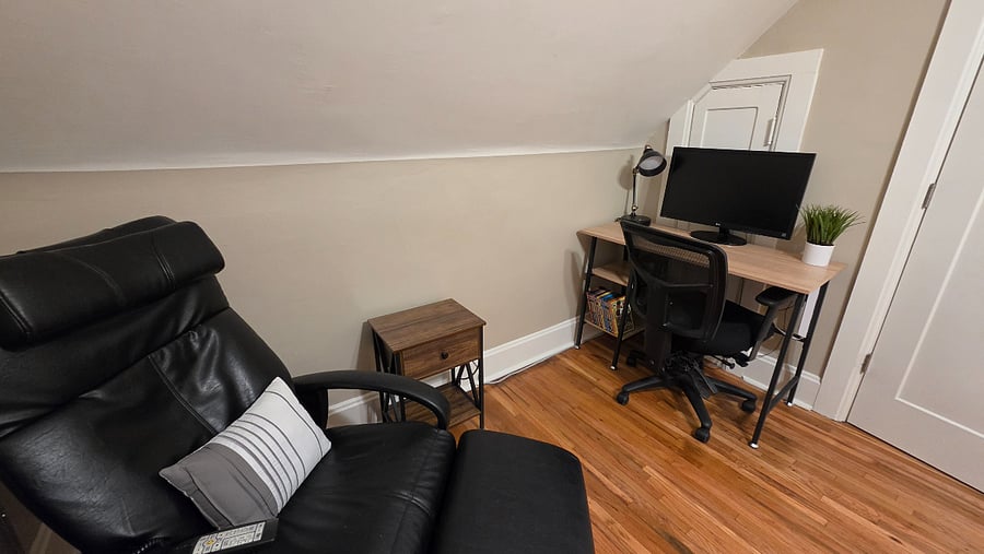 Massage chair and dedicated bedroom workspace for remote work, study, or personal use.