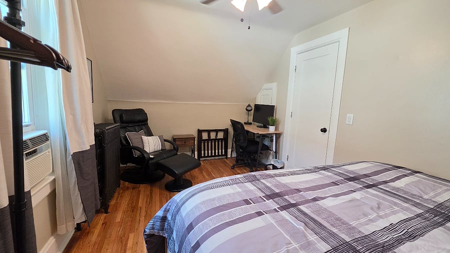 Flexible North Bedroom with a king setup or separate Twin XL beds, dedicated workspace, and massage chair for relaxing after the day.