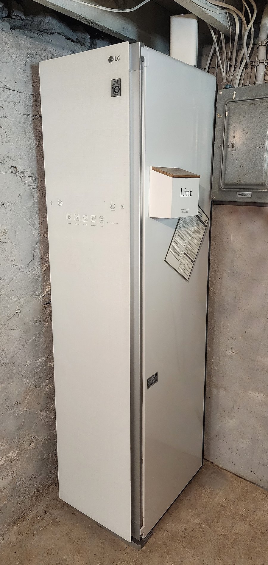 An LG Styler clothing care system helps refresh garments between washes-particularly handy for workwear and other clothing that benefits from gentle care. Located in the unfinished basement near the laundry area.