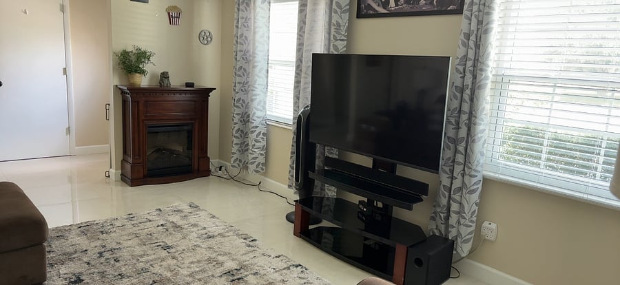 Cozy living room with sectional sofa, 55" Smart TV, and electric fireplace.