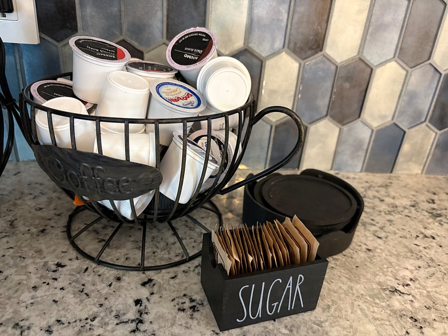 Coffee pods and sugar provided.