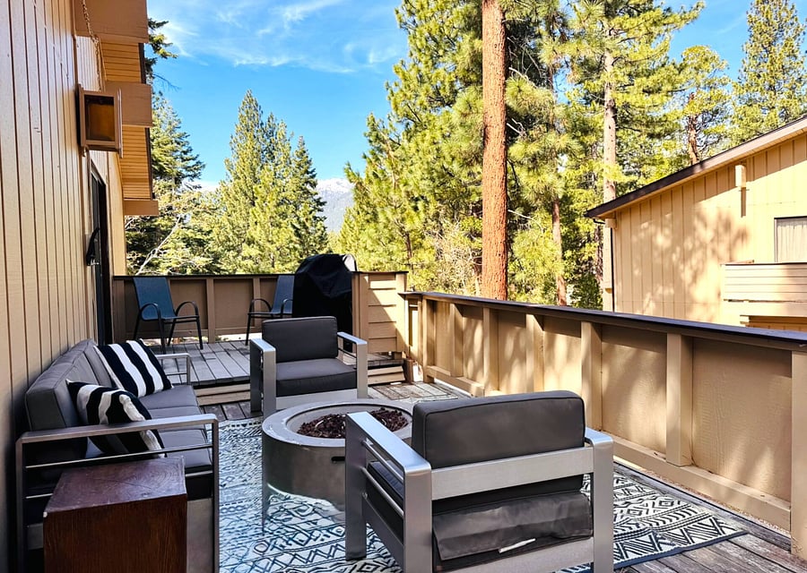 Main deck has great mountain views, and a cozy sitting area around a propane fire pit. Propane grill available for guest use.