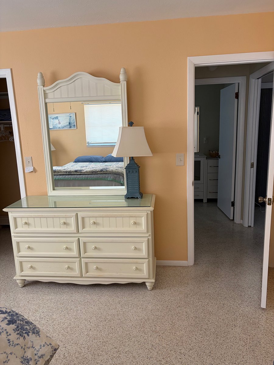 Dresser in bedroom with walk in closet.