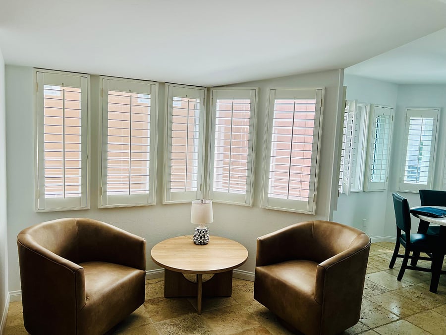 Lounge seating part of living room with swivel chairs which can also turn to chat with people in the kitchen