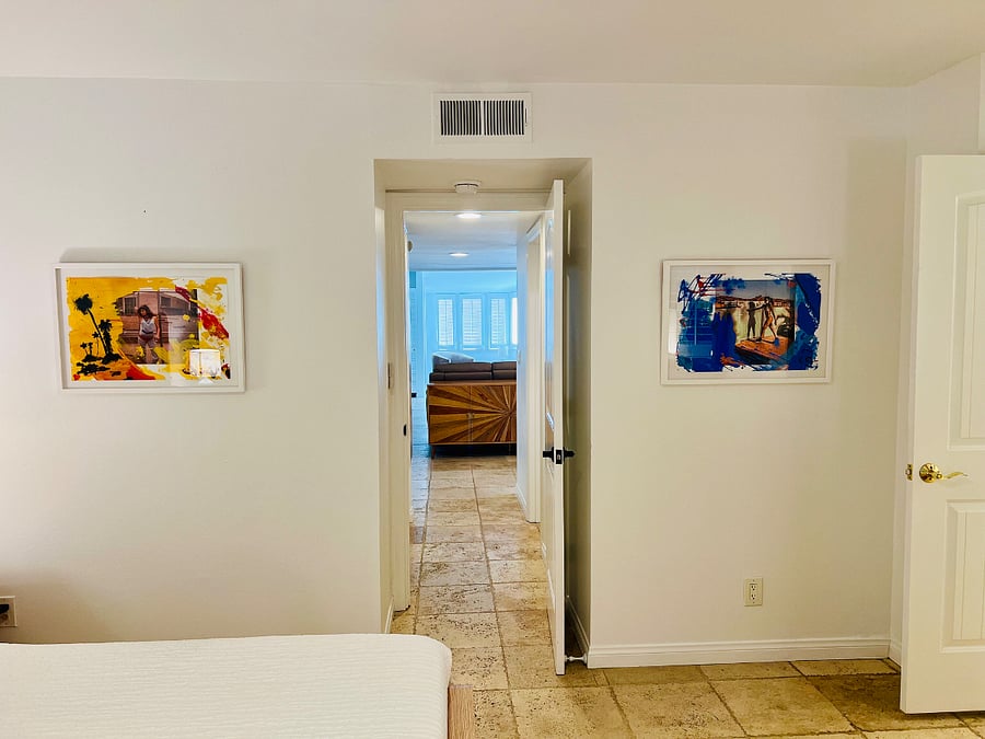 This is the view looking from the primary bedroom through the condo into the den area