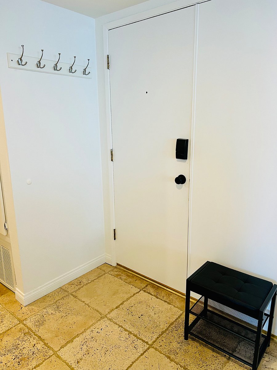 This is just inside of the front door, with a shoe bench and hooks for keys.